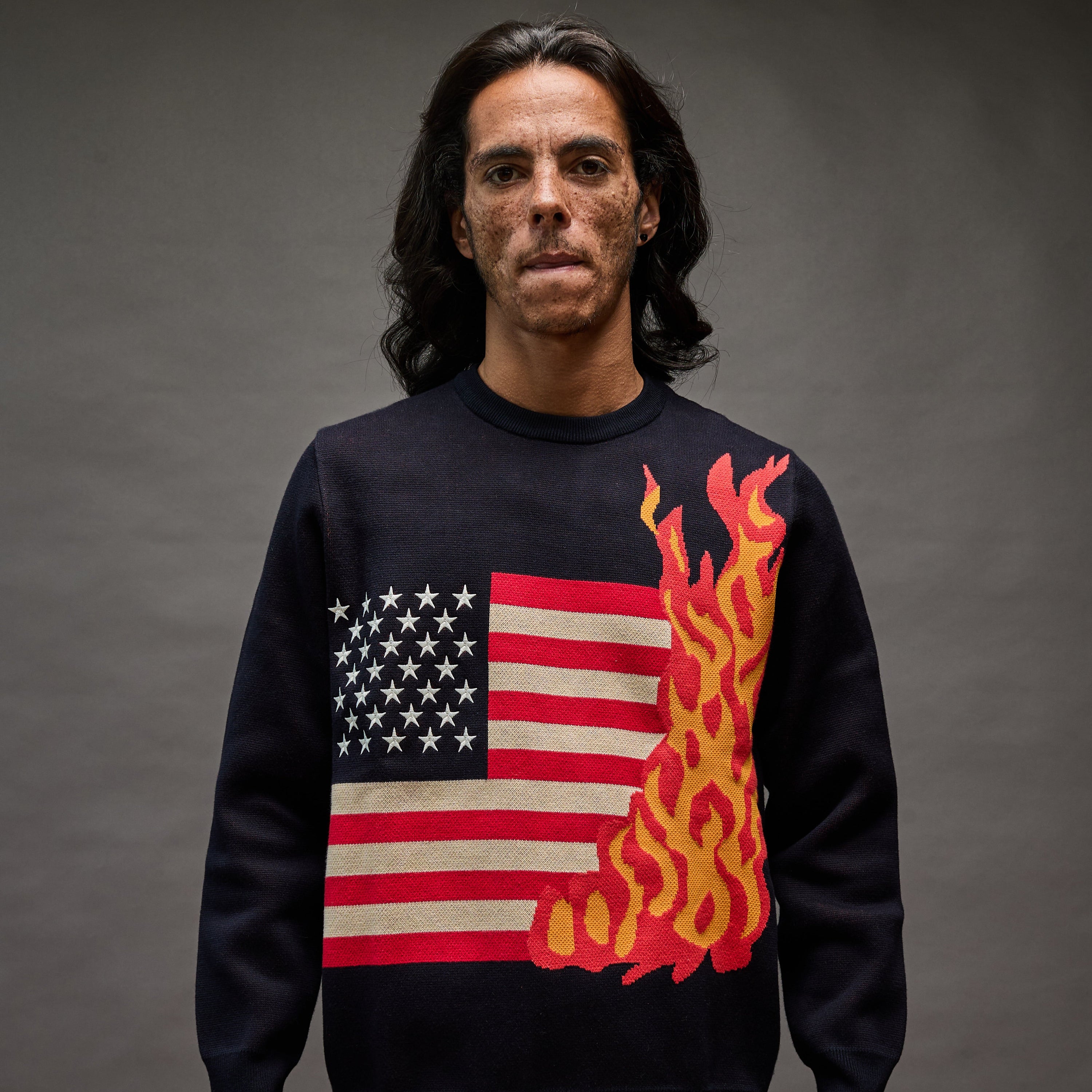 “Cola Corporation 1A Sparks sweater with burning American flag graphic front view”