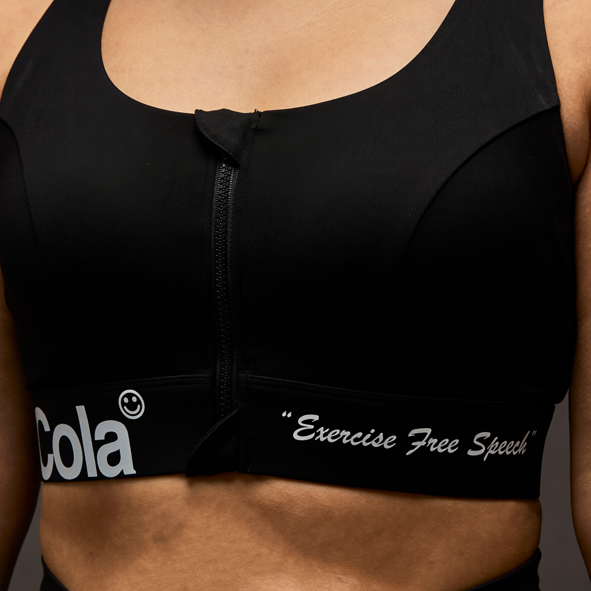 Person wearing a black sports bra with visible branding and text that says, "Exercise free speech."